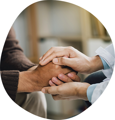 Doctor holding a patient's hands in their own