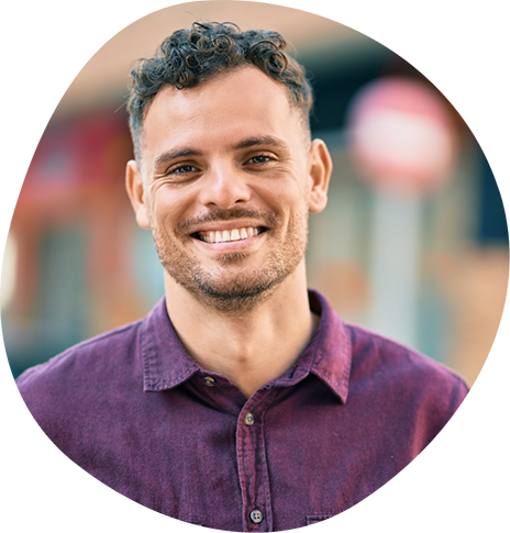 Smiling man in a purple collared shirt