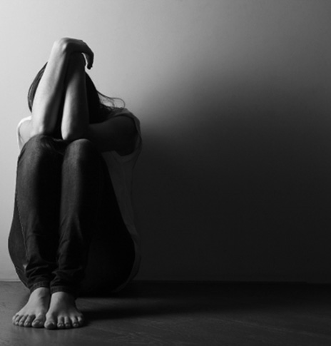 Sad woman sitting on the floor
