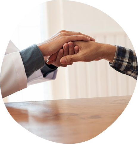 Psychiatrist holding a patient's hand in both of their own