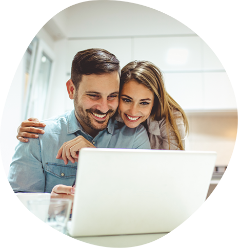 Smiling man and woman looking at a laptop together
