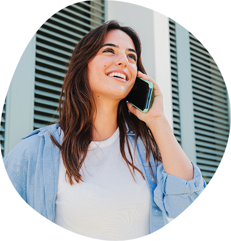 Smiling woman talking on the phone outdoors