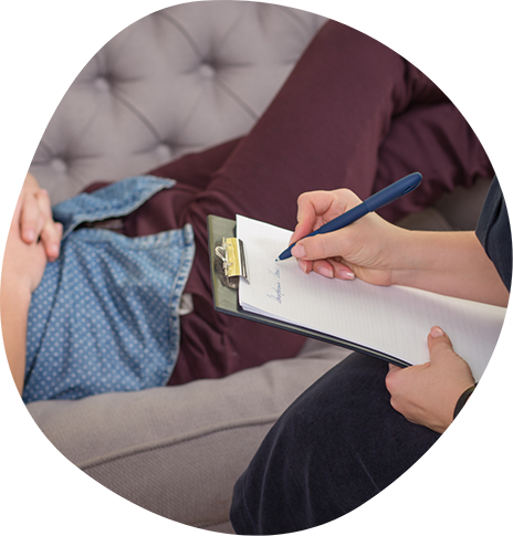 Psychiatrist taking notes while talking with a patient