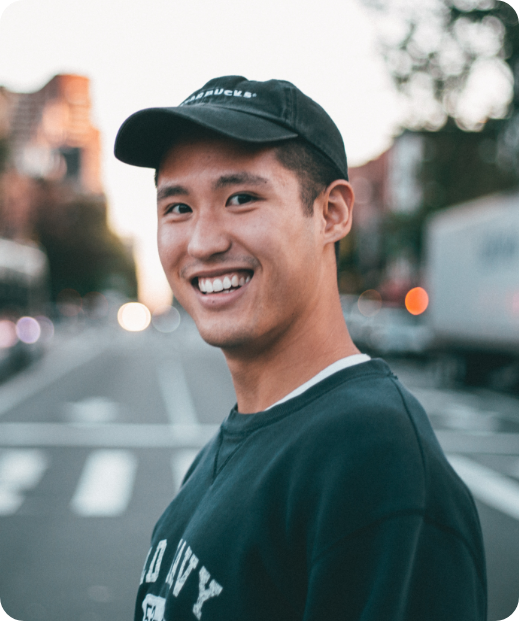 Man smiling on a sidewalk after seeing a psychiatrist for medication management