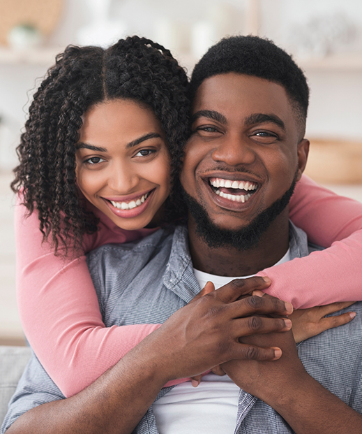 Smiling man and woman embracing after seeing psychiatric providers in Austin