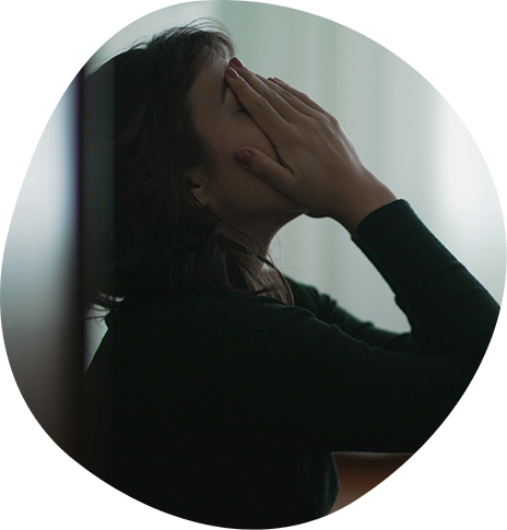 Woman holding her head in her hands