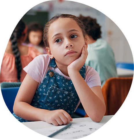 Young girl looking bored in a classroom